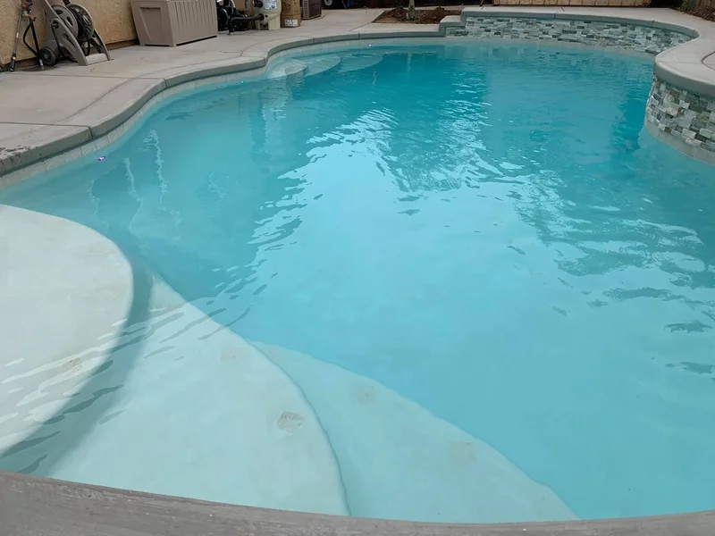 Close-up of pool remodel with fresh plaster and tile accents