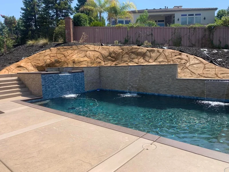 Hillside pool with landscaped retaining wall and plants