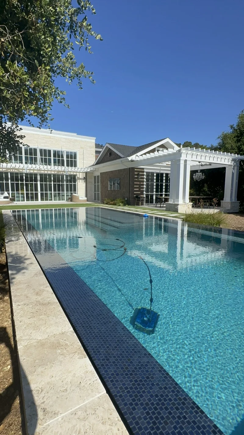 Aerial of a pool with an integrated spa and bubbling jets