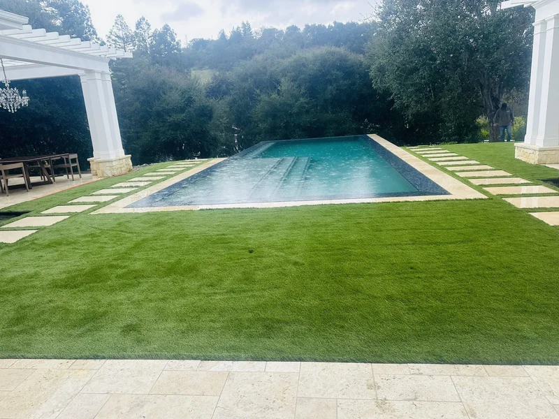 Resort-style pool with a white patio deck and lounge seating