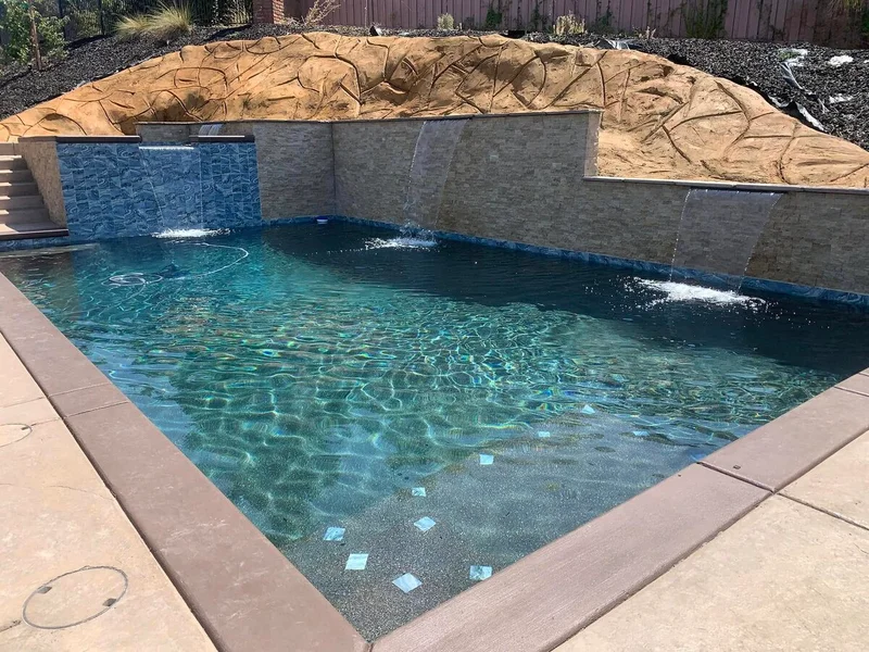 Pool with stone retaining wall and decorative features