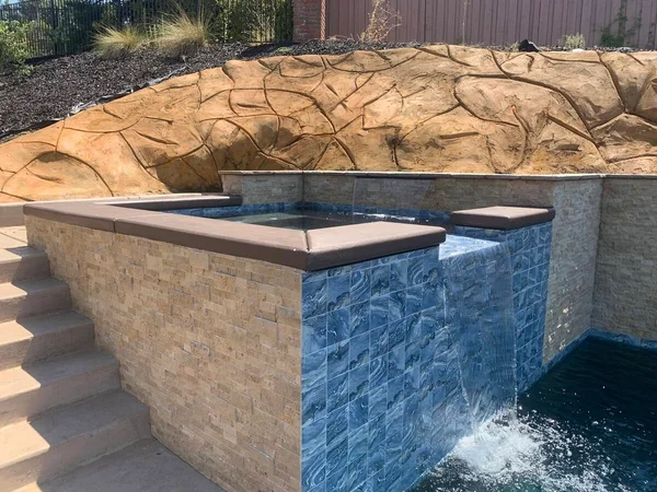 Spa with Blue Tile & Waterfall by Infinity E. Pools in Northern California