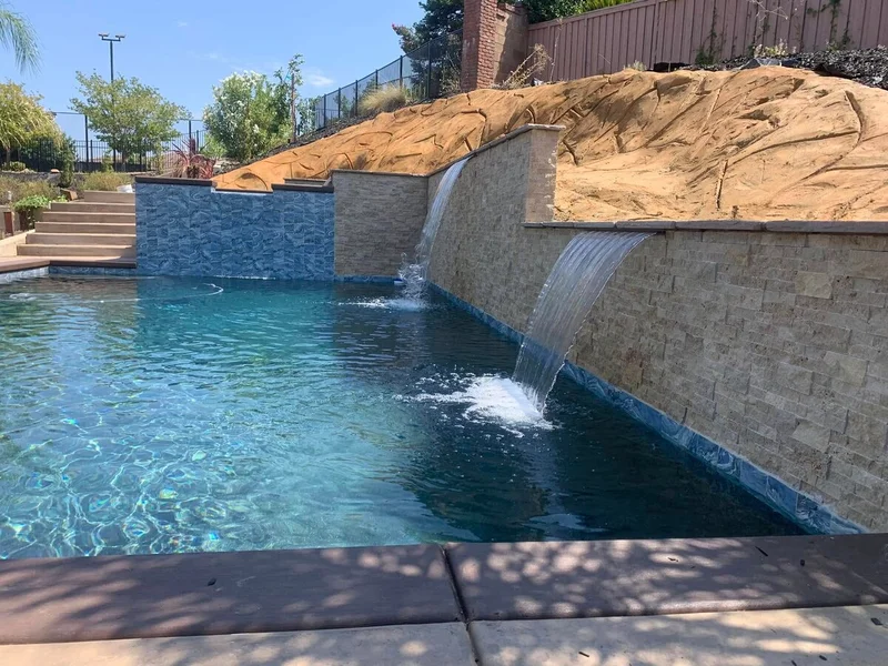 Pool with natural stone wall and waterfall cascade